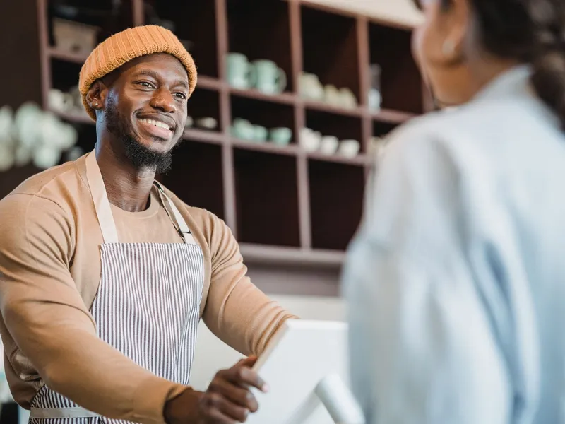 Business owner talking with a happy customer