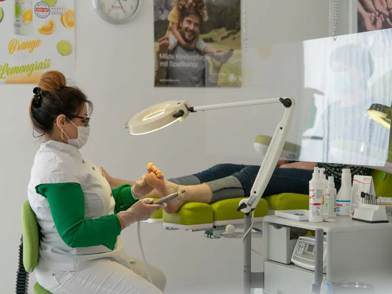 Podiatrist treating a patient's foot in a clinic