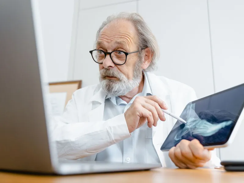 Doctor reviewing a foot X-ray on a tablet