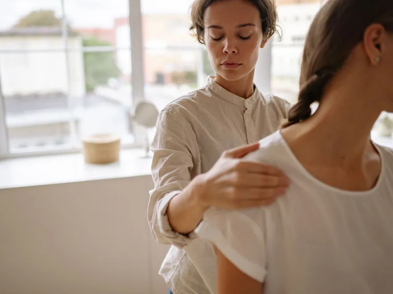 Physical therapist working on a patient's shoulder